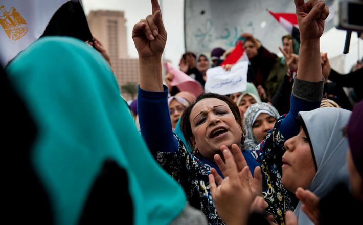 A woman leads singing during a demonstration in Tahrir Square in Cairo, Egypt. The group demanded the overthrow of the regime of Egyptian President Hosni Mubarak in February 2011. (Monique Jaques / Corbis via Getty Images