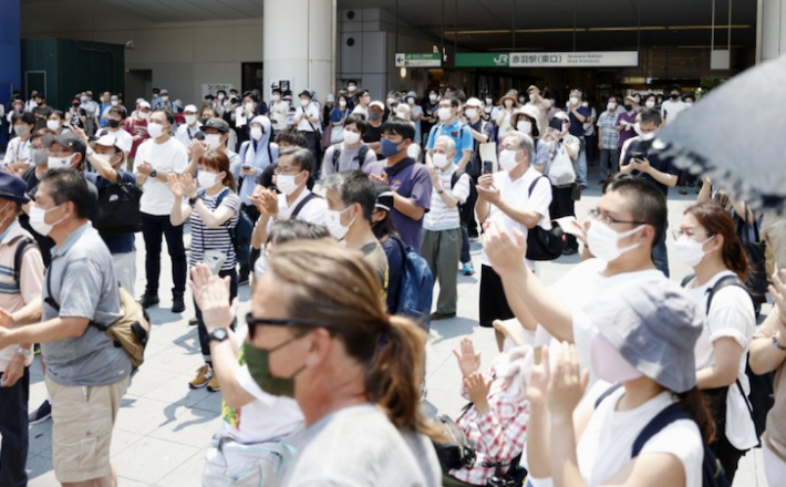 Photo taken on July 2, 2022, shows people listening to street campaigns in Tokyo ahead of the July 10 House of Councillors election. (Kyodo)