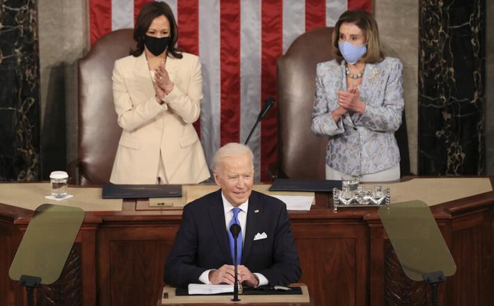 In a historic first, President Biden was flanked by two women — House Speaker Nancy Pelosi and Vice President Harris — as he addressed a joint session of Congress at the U.S. Capitol on Wednesday. Chip Somodevilla/Bloomberg via Getty Images