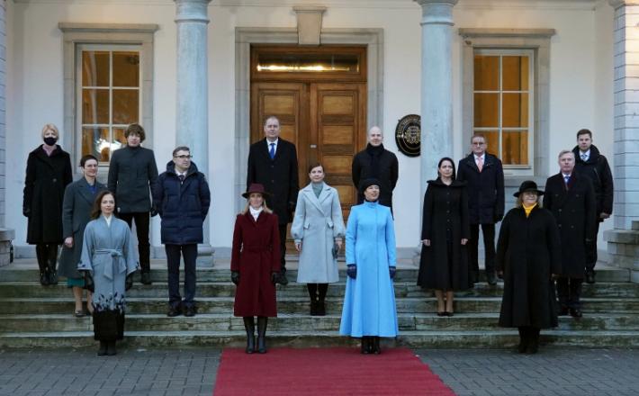 رئيسة إستونيا وإلى يمينها رئيسة الوزراء مع أعضاء الحكومة الجديدة (رويترز)