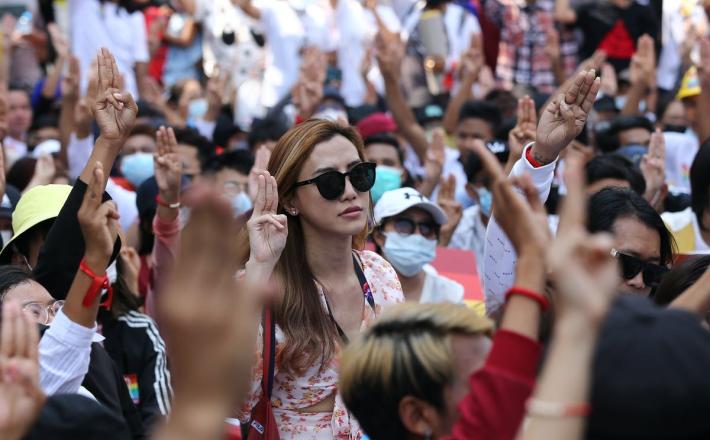 Anti-coup protesters flash the three-fingered salute during a rally in downtown Yangon, Myanmar on Feb. 19, 2021. (AP Photo)