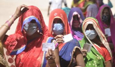 Women show voter ID cards during Panchayat election, at Bakkas polling centre on April 19, 2021 in Lucknow, India. Deepak Gupta/Hindustan Times via Getty Images / Time 
