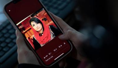 A woman looks at a picture of former Afghan lawmaker Mursal Nabizada on her mobile phone, who was shot dead by gunmen at her house in Kabul on January 15, 2023.