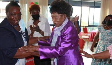 Maendeleo Ya Wanawake national vice-chairperson Anne Kibet congratulates Pheobe Asiyo after gifting her with a head ornament during Asiyo's 90th birthday celebrations in Homa Bay town. [James Omoro, Standard]
