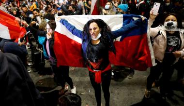  A woman holds a Chilean flag in Valparaiso last year. In a referendum in October, Chileans voted by a 79% landslide majority in favor of a popularly elected citizen assembly with gender parity. Photograph: Rodrigo Garrido/Reuters