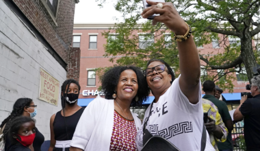 Acting Mayor Kim Janey, left, takes a selfie with Mikey Miles as she meets people in Boston’s Nubian Square for a Juneteenth 2021 event.(Elise Amendola / Associated Press)